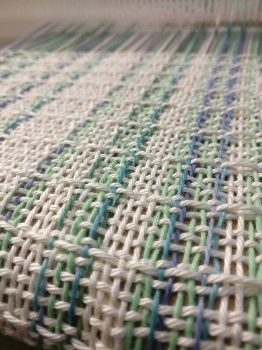 Close up of pick up textured fabric on the loom