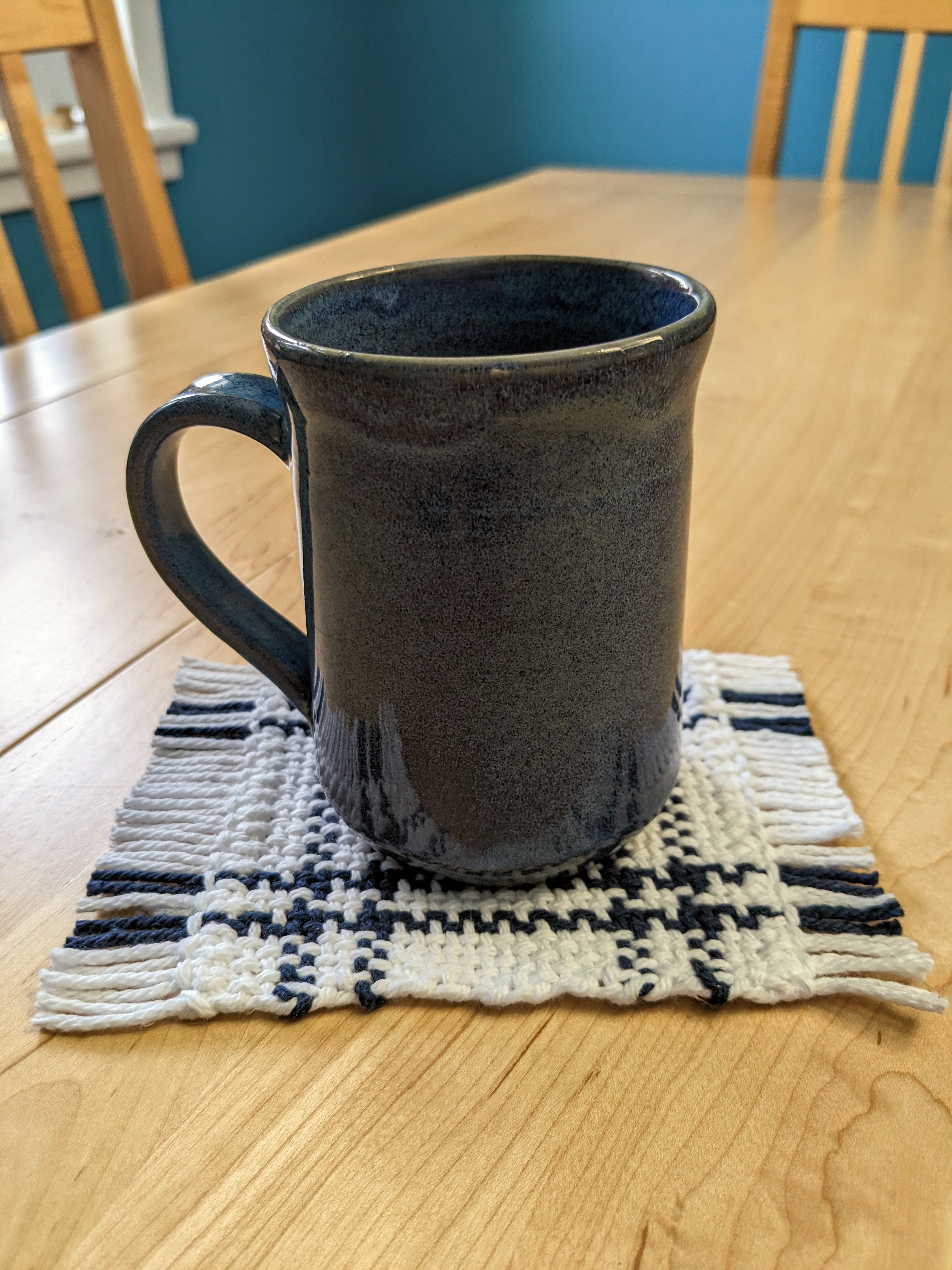 Photo of the coaster from this pattern being used with a blue pottery mug